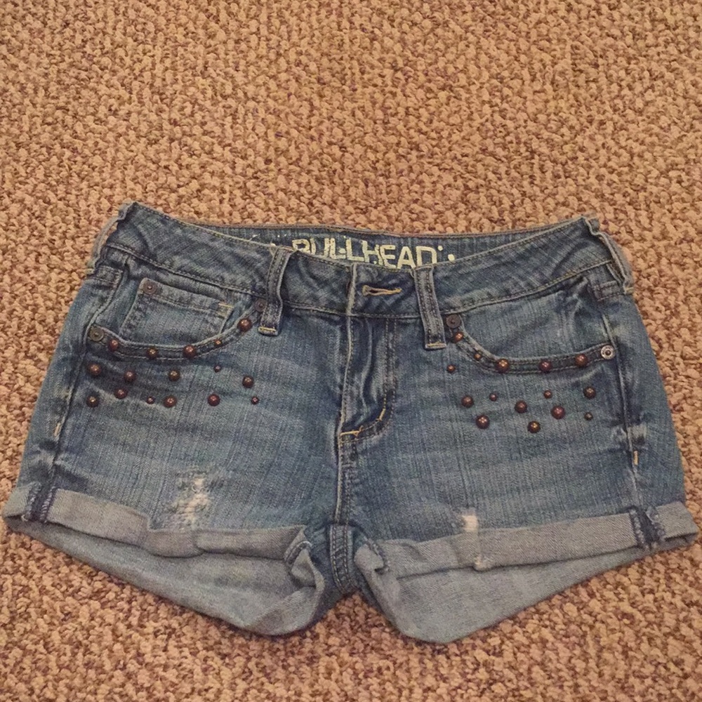 Bullhead jean shorts with bronze embellishments